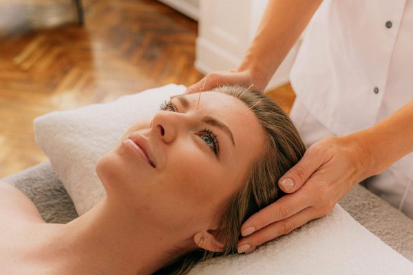 A tranquil moment during a spa session with a woman receiving a relaxing massage. Perfect for wellness themes.